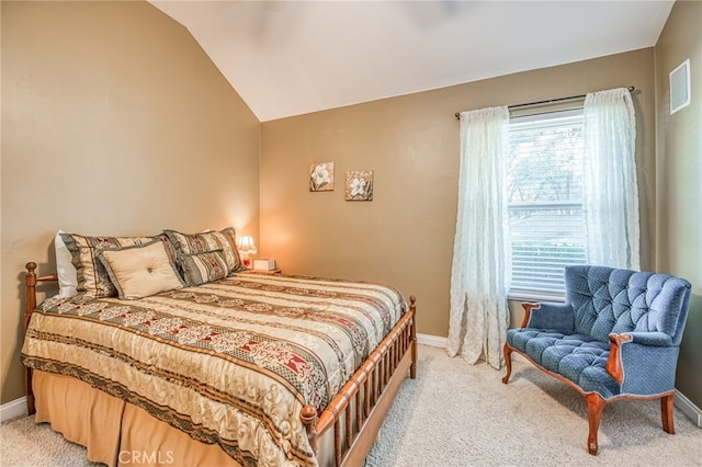 carpeted bedroom with lofted ceiling