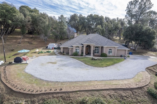 ranch-style home featuring a front yard and a garage