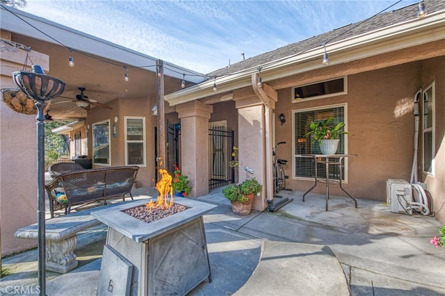 view of patio featuring ceiling fan and an outdoor fire pit