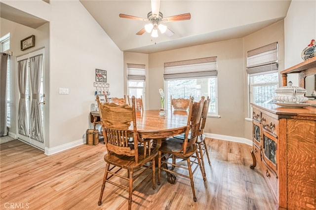 dining area featuring ceiling fan, light hardwood / wood-style floors, and vaulted ceiling