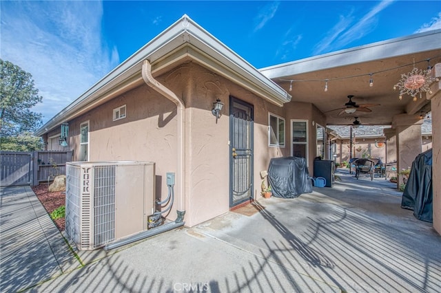 entrance to property featuring a patio, central AC unit, and ceiling fan