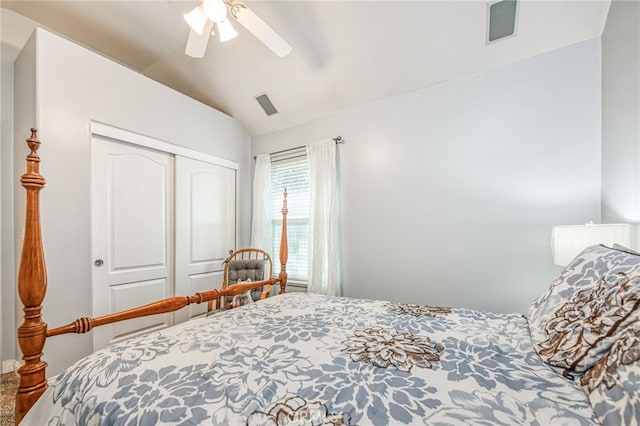 carpeted bedroom featuring ceiling fan, a closet, and vaulted ceiling