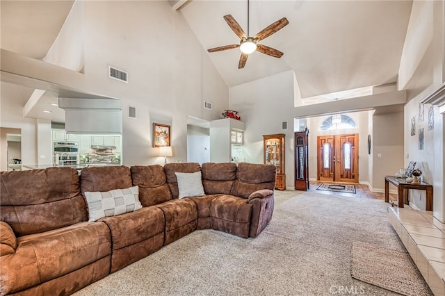 living room with carpet flooring, ceiling fan, and high vaulted ceiling