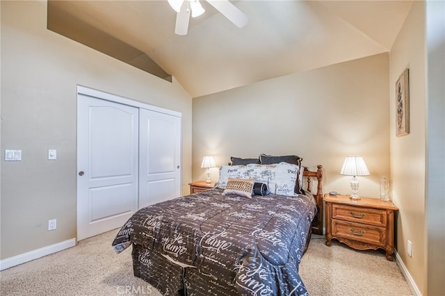 bedroom with ceiling fan, light colored carpet, lofted ceiling, and a closet