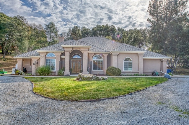 view of front of house featuring a front yard and french doors