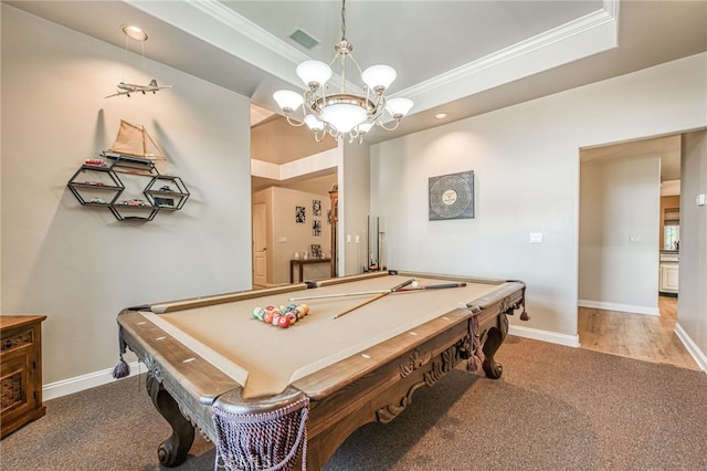 recreation room with an inviting chandelier, crown molding, pool table, a tray ceiling, and light colored carpet