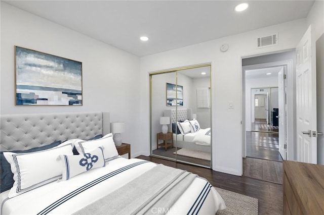 bedroom featuring a closet and dark hardwood / wood-style floors