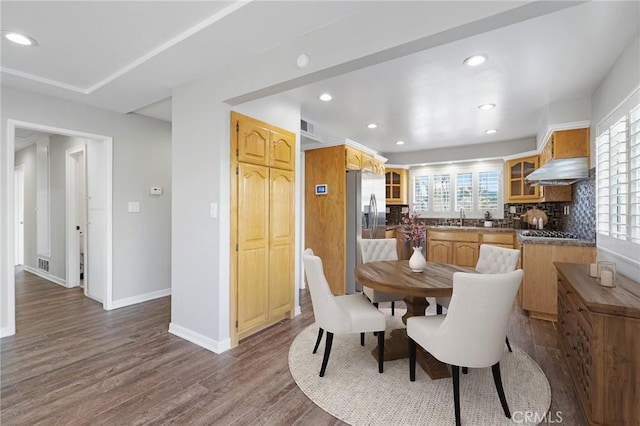 dining space with dark hardwood / wood-style flooring and sink