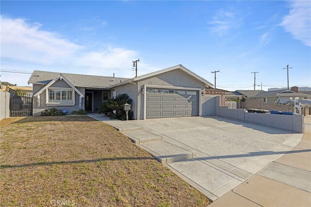 ranch-style home with a garage and a front lawn