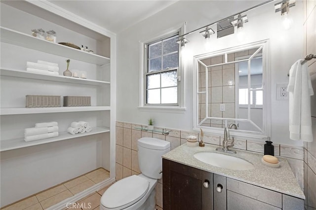 bathroom featuring tile walls, tile patterned flooring, vanity, and toilet