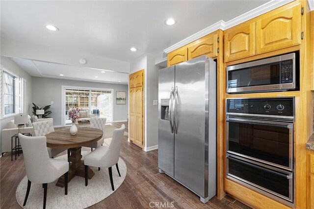 kitchen with stainless steel appliances and dark hardwood / wood-style flooring