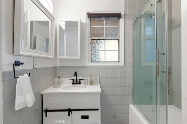 bathroom featuring enclosed tub / shower combo and vanity