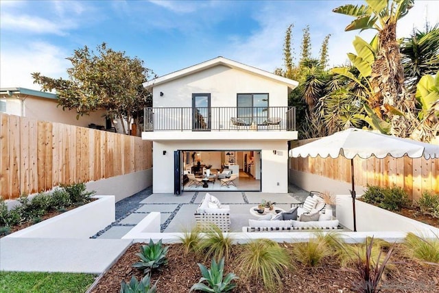 rear view of house featuring an outdoor hangout area and a balcony