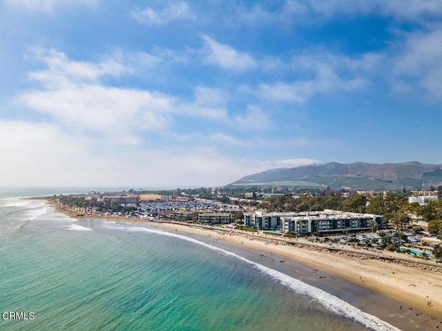 birds eye view of property with a view of the beach and a water and mountain view