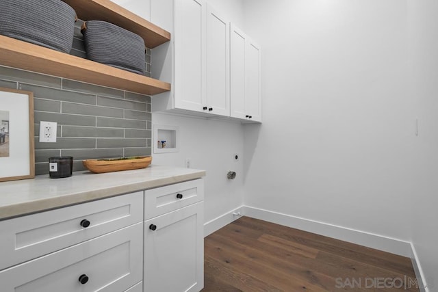 laundry room featuring dark hardwood / wood-style flooring, washer hookup, hookup for an electric dryer, and cabinets