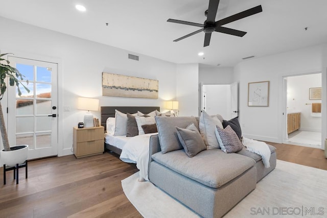 bedroom featuring ceiling fan, wood-type flooring, and ensuite bath