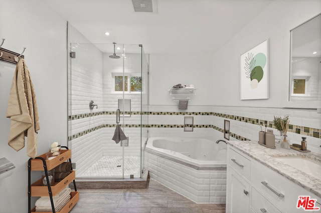 bathroom with vanity and independent shower and bath