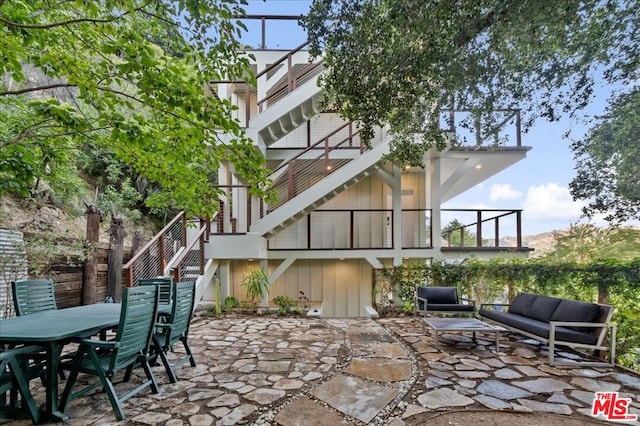 view of patio / terrace featuring an outdoor living space and a balcony