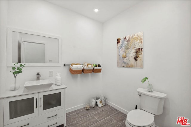 bathroom with toilet and vanity