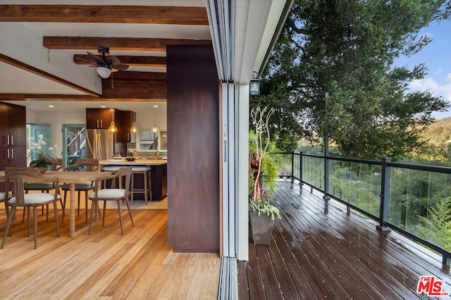 wooden deck featuring ceiling fan