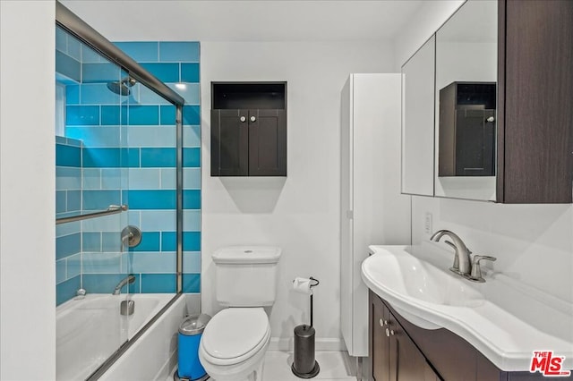 full bathroom with toilet, combined bath / shower with glass door, and vanity