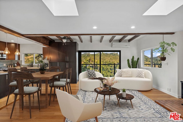 living room featuring a skylight, beam ceiling, and plenty of natural light