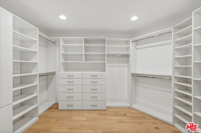 walk in closet featuring light hardwood / wood-style flooring