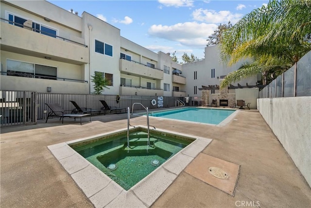 view of pool featuring a patio area and a hot tub