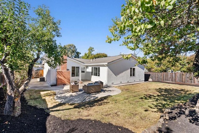 back of property featuring outdoor lounge area, a lawn, and a patio area