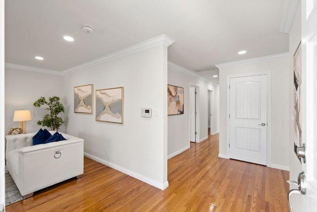 corridor with crown molding and light hardwood / wood-style floors