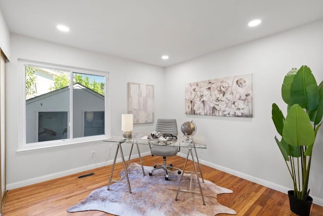 home office with hardwood / wood-style floors