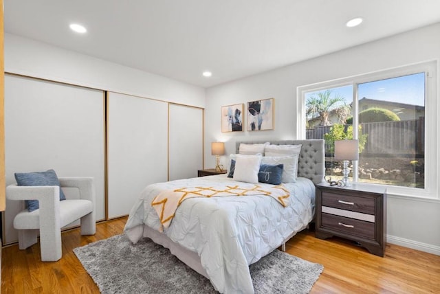 bedroom with a closet and light hardwood / wood-style flooring