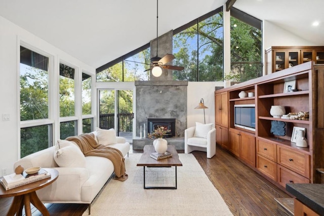 sunroom / solarium featuring vaulted ceiling, a large fireplace, and ceiling fan