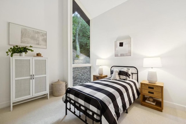 carpeted bedroom featuring vaulted ceiling