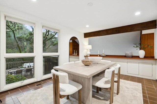 dining area with beam ceiling