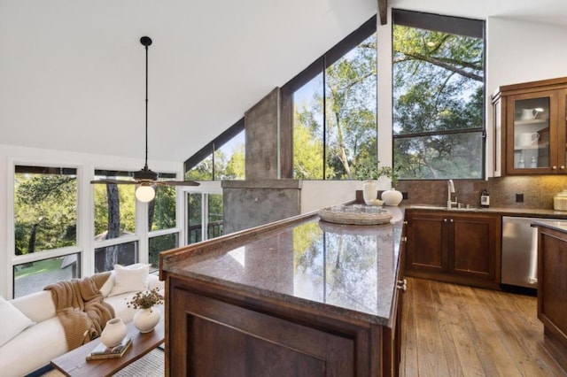 sunroom featuring lofted ceiling with beams, sink, and ceiling fan