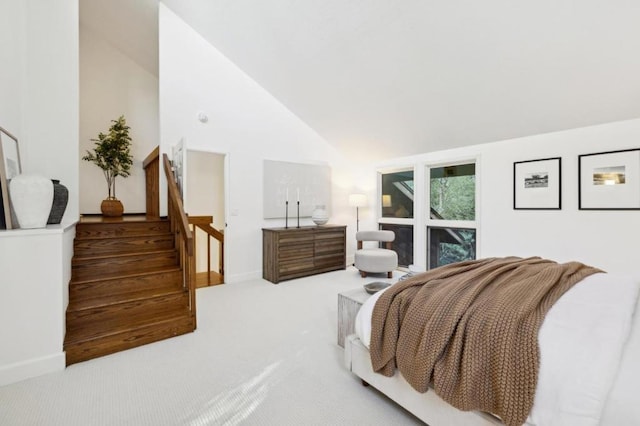 bedroom featuring high vaulted ceiling and carpet floors