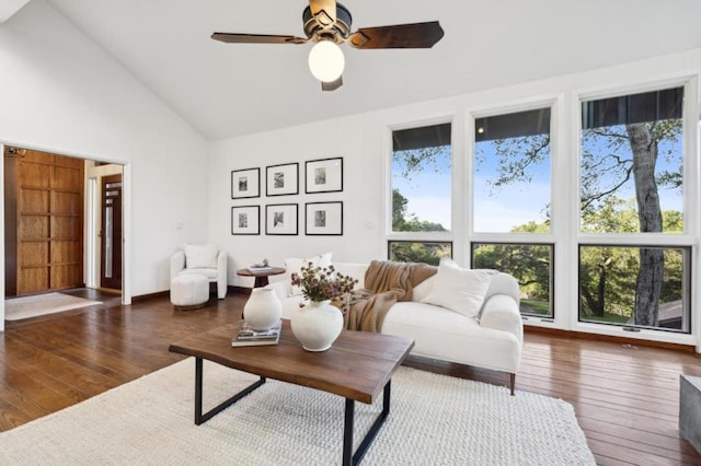 living room with ceiling fan, dark hardwood / wood-style flooring, and high vaulted ceiling