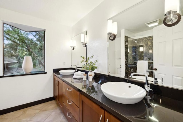 bathroom featuring tiled shower, vanity, and tile patterned floors