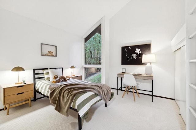 carpeted bedroom with vaulted ceiling