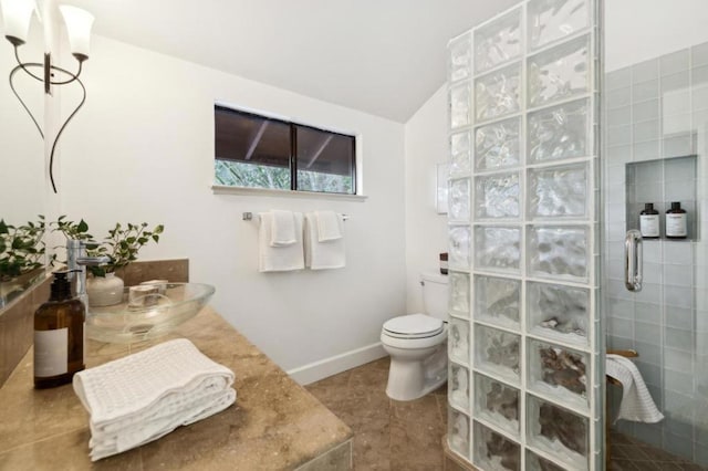 bathroom with walk in shower, toilet, tile patterned flooring, and vaulted ceiling