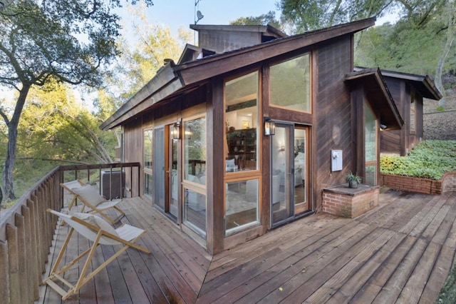 wooden deck with a sunroom