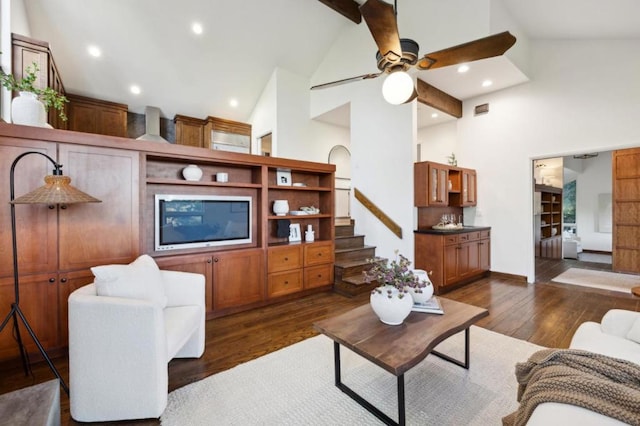 living room featuring dark hardwood / wood-style flooring, ceiling fan, and high vaulted ceiling