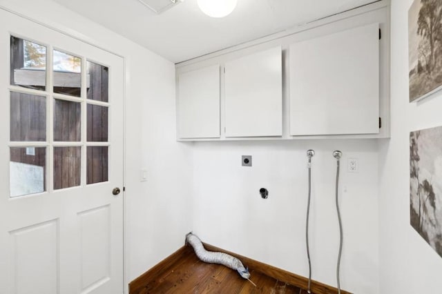 laundry area featuring cabinets, dark hardwood / wood-style flooring, and electric dryer hookup