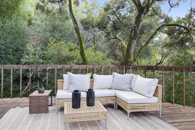 wooden terrace with an outdoor living space