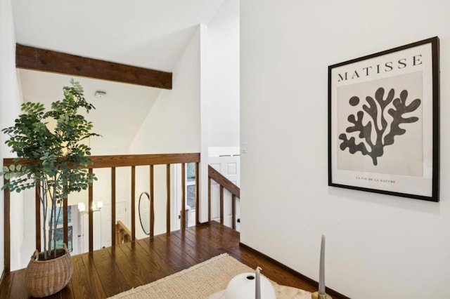 staircase with hardwood / wood-style flooring and lofted ceiling with beams