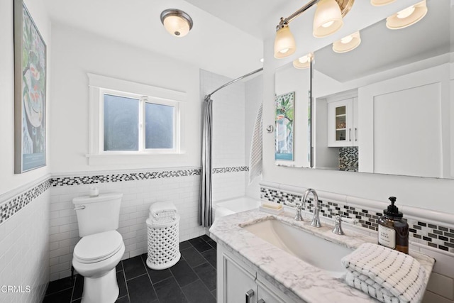 bathroom with tile patterned floors, toilet, vanity, and a shower with curtain