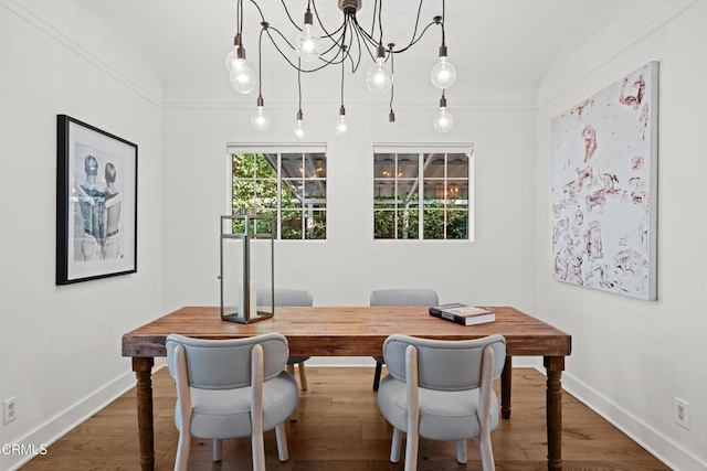 office with an inviting chandelier, ornamental molding, and hardwood / wood-style floors