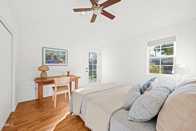 bedroom with ceiling fan, hardwood / wood-style flooring, and vaulted ceiling