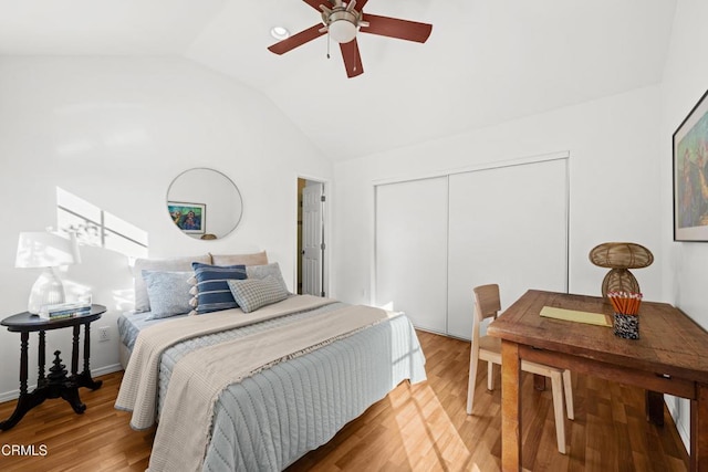 bedroom with ceiling fan, lofted ceiling, hardwood / wood-style flooring, and a closet